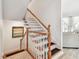 Beautiful wooden staircase with carpet runners and white railings, leading to a bright and inviting living area at 6412 Mayra Shores Ln, Apollo Beach, FL 33572