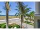 Pleasant street view showcasing lush greenery and glimpses of the ocean, creating a serene atmosphere at 6412 Mayra Shores Ln, Apollo Beach, FL 33572