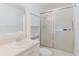 Bright bathroom featuring a vanity with a sink, a cabinet for storage, and a glass-enclosed shower at 646 Allegheny Dr, Sun City Center, FL 33573