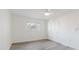 Spacious bedroom features light gray floors, ceiling fan, closet, and a window at 646 Allegheny Dr, Sun City Center, FL 33573