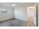 Bright bedroom with a ceiling fan, light gray floors, a window, and large closet at 646 Allegheny Dr, Sun City Center, FL 33573