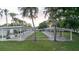 Open carport area nestled amongst mature trees and lush green lawns offering shaded parking for residents at 646 Allegheny Dr, Sun City Center, FL 33573
