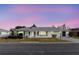 Charming one-story home with a well-manicured front yard and a welcoming facade at sunset at 646 Allegheny Dr, Sun City Center, FL 33573