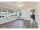 Bright Florida room with large windows offering a view of garden and stylish light wood flooring at 646 Allegheny Dr, Sun City Center, FL 33573