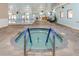 Indoor hot tub with grab rails, situated near the indoor pool at 646 Allegheny Dr, Sun City Center, FL 33573