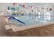 Indoor pool with lane markers, easy access steps, and pennant flags at 646 Allegheny Dr, Sun City Center, FL 33573