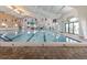 Bright indoor pool with lane markers, depth markers, and large windows at 646 Allegheny Dr, Sun City Center, FL 33573
