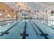 Bright indoor pool with lane markers and decorative flags at 646 Allegheny Dr, Sun City Center, FL 33573