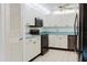 Efficient kitchen with white cabinets, modern appliances, and plenty of storage space at 646 Allegheny Dr, Sun City Center, FL 33573