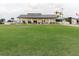 Wide lawn bowling green surrounded by benches and shade offering an active recreational space at 646 Allegheny Dr, Sun City Center, FL 33573