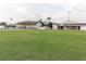 Expansive lawn bowling green, benches, and clubhouse for an engaging outdoor recreation area at 646 Allegheny Dr, Sun City Center, FL 33573