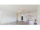 Spacious living room with arched doorways, neutral-toned walls, and sleek, modern light wood floors at 646 Allegheny Dr, Sun City Center, FL 33573