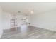 Open-concept living area featuring arched doorways, natural light, and updated modern flooring at 646 Allegheny Dr, Sun City Center, FL 33573