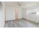 Bright main bedroom with wood-look floors, white walls, and a ceiling fan at 646 Allegheny Dr, Sun City Center, FL 33573