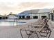 Outdoor community pool with patio, lounge chairs and umbrellas at 646 Allegheny Dr, Sun City Center, FL 33573