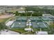 Aerial view of multiple tennis courts and surrounding community at 646 Allegheny Dr, Sun City Center, FL 33573
