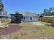 Backyard showing screened porch, fire pit area, and privacy fence at 6811 S Himes Ave, Tampa, FL 33611