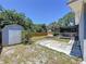 Spacious backyard featuring a storage shed, patio, and screened-in porch, perfect for outdoor relaxation at 6811 S Himes Ave, Tampa, FL 33611