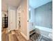 Nicely remodeled bathroom with eye-catching hexagonal tile, framed mirror, and modern fixtures at 6811 S Himes Ave, Tampa, FL 33611