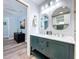 Bathroom with a double sink vanity, decorative mirrors, and a modern shower with glass enclosure at 6811 S Himes Ave, Tampa, FL 33611