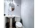 Small updated bathroom featuring a pedestal sink and modern toilet at 6811 S Himes Ave, Tampa, FL 33611