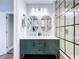 Elegant bathroom boasts a double sink vanity with marble countertop and a modern shower with sleek glass partition at 6811 S Himes Ave, Tampa, FL 33611
