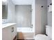 Bathroom features a white vanity and tub with elegant gray hexagonal tile surround at 6811 S Himes Ave, Tampa, FL 33611