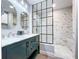 Stylish bathroom featuring a double vanity, a modern shower with glass enclosure, and marble accents at 6811 S Himes Ave, Tampa, FL 33611