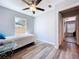 Bedroom boasting a ceiling fan, wood flooring, and doorway leading to the hallway at 6811 S Himes Ave, Tampa, FL 33611