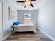 Bright, clean bedroom featuring wood floors, ceiling fan and a large window at 6811 S Himes Ave, Tampa, FL 33611