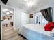 Bedroom featuring sliding glass doors to sunroom, closet, ceiling fan and neutral paint at 6811 S Himes Ave, Tampa, FL 33611