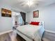 Bright bedroom with wood-look floors and glass sliding doors to sunroom at 6811 S Himes Ave, Tampa, FL 33611