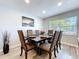 The dining room features a large table with seating for six and a contemporary decor at 6811 S Himes Ave, Tampa, FL 33611