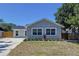 Charming single-story home featuring a landscaped front yard and a well-manicured lawn at 6811 S Himes Ave, Tampa, FL 33611