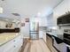 Charming kitchen boasts stainless steel appliances and granite countertops at 6811 S Himes Ave, Tampa, FL 33611
