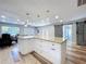 Spacious kitchen island with granite counters and modern pendant lighting at 6811 S Himes Ave, Tampa, FL 33611