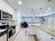 Bright kitchen with stainless appliances overlooks dining and living areas at 6811 S Himes Ave, Tampa, FL 33611