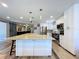 Granite kitchen island connects to stainless fridge and appliances at 6811 S Himes Ave, Tampa, FL 33611