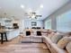 The living room gives an open concept view into the kitchen with island and barstool seating at 6811 S Himes Ave, Tampa, FL 33611