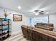 Open-concept living space featuring neutral paint, ceiling fan, and wood-look floors at 6811 S Himes Ave, Tampa, FL 33611