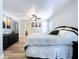 Spacious main bedroom featuring wood floors, ceiling fan and a closet/bathroom at 6811 S Himes Ave, Tampa, FL 33611