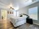 Inviting main bedroom featuring a ceiling fan, wood floors, and natural light from the window at 6811 S Himes Ave, Tampa, FL 33611