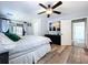 Inviting main bedroom with a ceiling fan, wood floors, and a calming atmosphere at 6811 S Himes Ave, Tampa, FL 33611