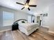 Comfortable main bedroom features a ceiling fan, wood floors, and access to the backyard through sliding doors at 6811 S Himes Ave, Tampa, FL 33611