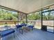 Relaxing screened-in patio with comfortable seating and serene backyard views with lots of foliage at 6811 S Himes Ave, Tampa, FL 33611