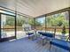 Covered back porch with outdoor seating overlooking a fenced in backyard at 6811 S Himes Ave, Tampa, FL 33611
