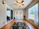 Sunroom features wood floors, fan, and sliding glass doors for natural light at 6811 S Himes Ave, Tampa, FL 33611