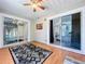 Relaxing sunroom featuring wood floors, a ceiling fan, and sliding glass doors to the bedroom and backyard at 6811 S Himes Ave, Tampa, FL 33611