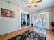 Bright sunroom with wood floors, a sliding glass door to the outside, and a view to the bedroom at 6811 S Himes Ave, Tampa, FL 33611