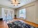 Cozy sunroom with french doors, a ceiling fan, and warm wood floors at 6811 S Himes Ave, Tampa, FL 33611